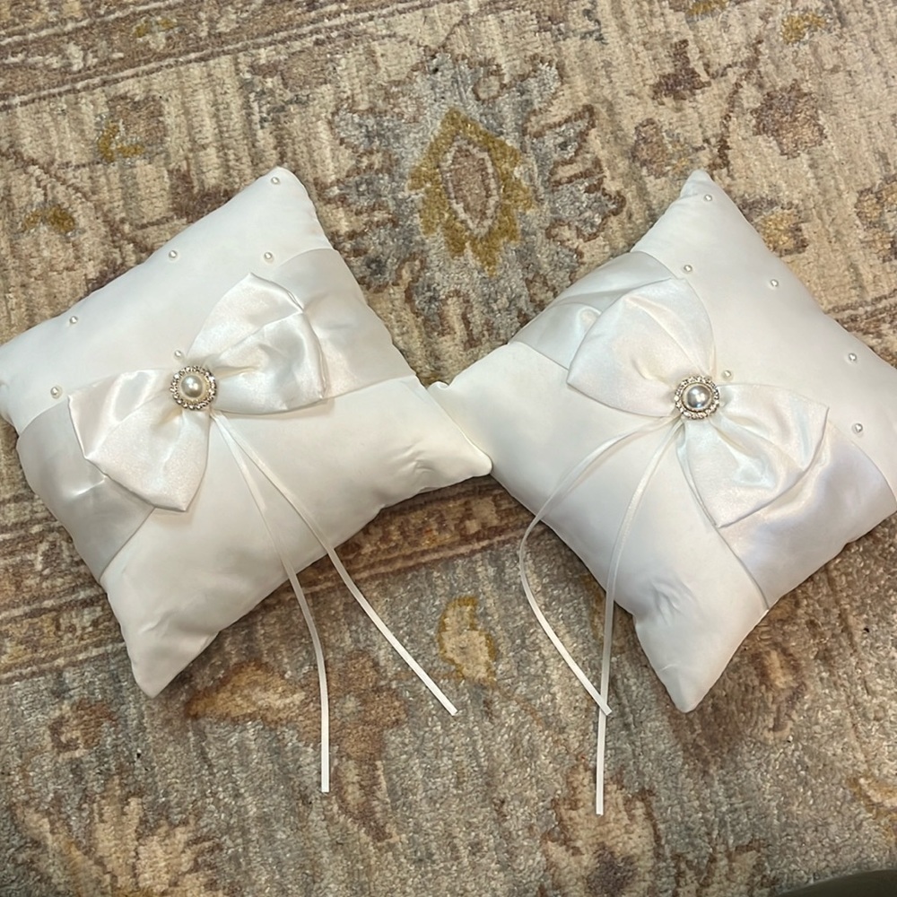 Two (or one, if you prefer) white wedding ring bearer pillows